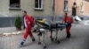 An elderly woman is carried on a stretcher by emergency service workers after a Russian missile attack on an apartment building in Lviv on July 6.