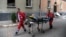 An elderly woman is carried on a stretcher by emergency service workers after a Russian missile attack on an apartment building in Lviv on July 6.