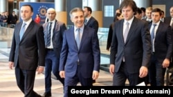 Georgian Dream Chairman Irakli Garibashvili (left), influential billionaire founder Bidzina Ivanishvili (center), and Prime Minister Irakli Kobakhidze (right) attend the party's congress in Tbilisi in February.