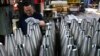 An employee handles 155mm caliber shells after the manufacturing process at the the Scranton Army Ammunition Plant in Scranton, Pennsylvania, on April 16.