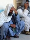 Relatives attend the funeral of an Afghan man who was killed in the suicide attack in Kandahar on March 21.