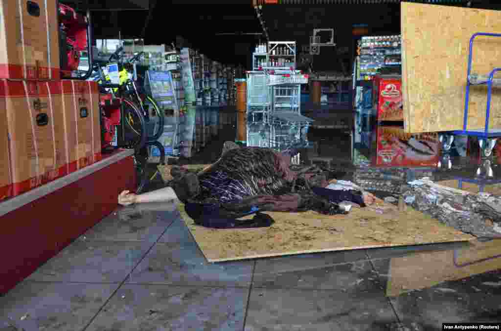 The body of a person killed by a Russian military strike is seen at a supermarket in Kherson on May 3. At least 23 people were killed in Russian strikes on&nbsp;a supermarket, a train station, residential buildings, a hardware store, and a gas station.