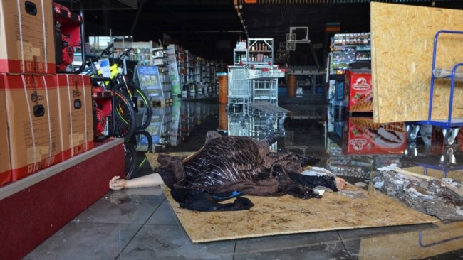 The body of a civilian killed by a Russian military strike is seen in a shopping mall in Kherson on May 3.