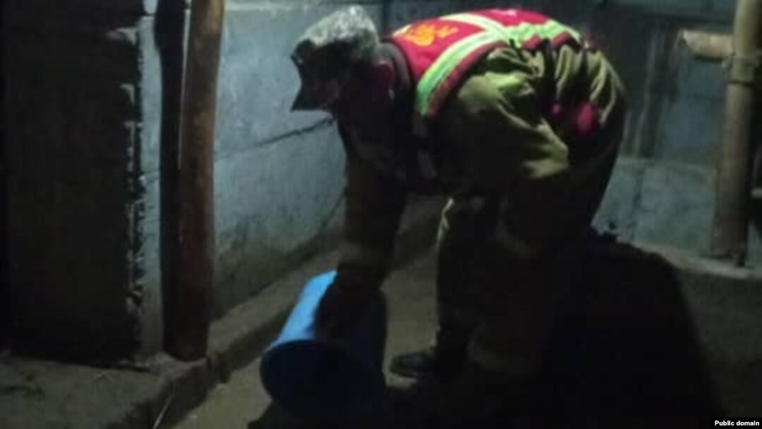 A Kyrgyz man clears water from a flooded house in Jalal-Abbad on April 21.
