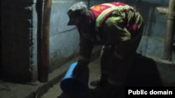 A Kyrgyz man clears water from a flooded house in Jalal-Abbad on April 21.
