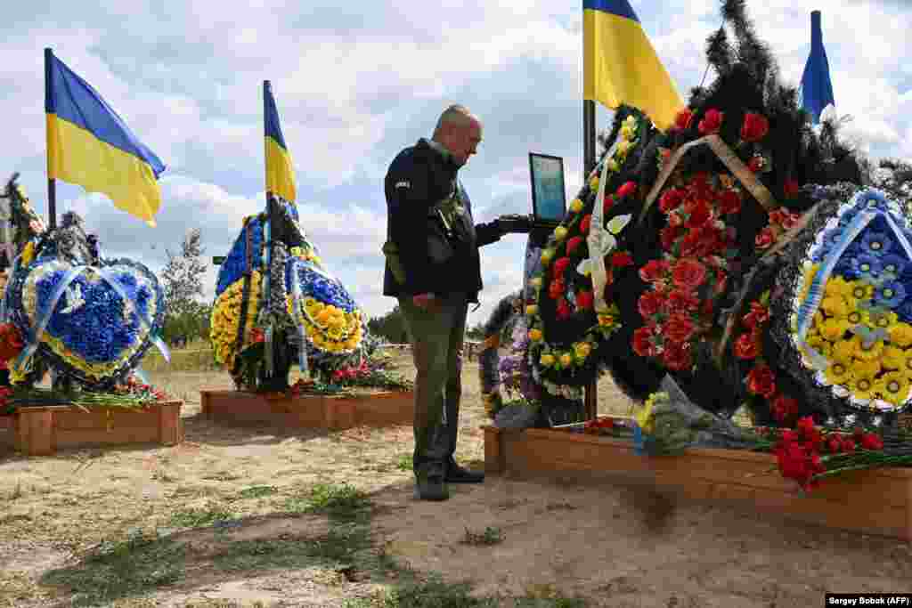 A local of Izyum, in eastern Ukraine, visits the Alley of Glory in the city&#39;s cemetery in September 2023.