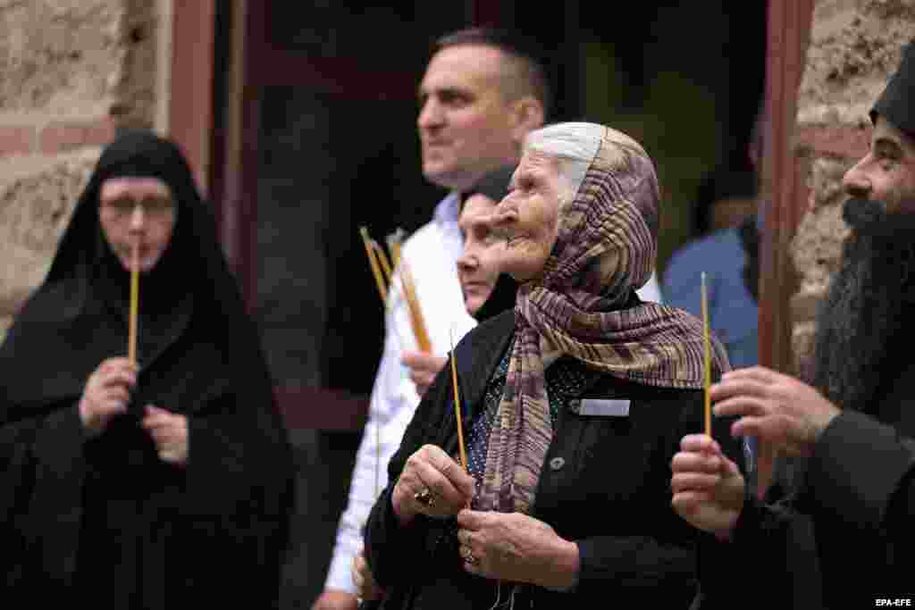 A woman holds a candle at the Gracanica monastery during the Vidovdan celebrations (St. Vitus Day) in Gracanica, Kosovo, on June 28. The Serbian Orthodox Church designates Vidovdan as a memorial day to St. Prince Lazar and the Serbian holy martyrs who fell during the Battle of Kosovo against the Ottoman Empire in 1389.