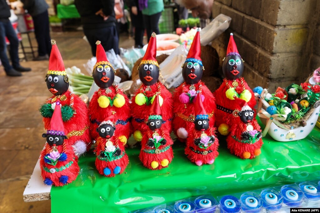 Figures of the fictional folklore character Hajji Firuz, who appears in the streets at the beginning of Norouz, are displayed at a stall in Tehran ahead of the festival.    