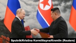 Russian President Vladimir Putin and North Korean leader Kim Jong Un shake hands in Pyongyang on June 19. 