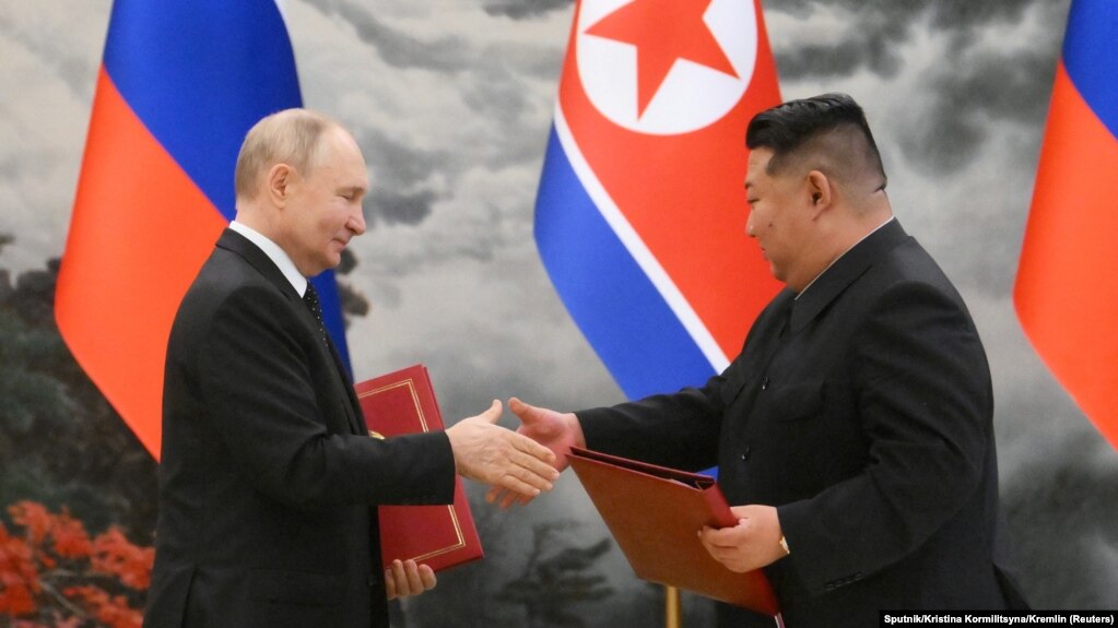 Russian President Vladimir Putin (left) shakes hands with North Korean leader Kim Jong Un at a signing ceremony following bilateral talks in Pyongyang on June 19. 