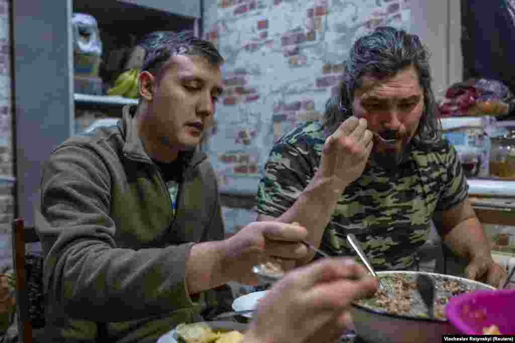 Soldiers enjoy their Christmas Eve dinner, and a brief break in action, before heading out and taking up positions. The tank unit had little time to celebrate as fighting continues to rage in the region.