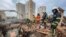 Rescuers work at a site of a residential building damaged by a Russian strike in Kharkiv on October 6.