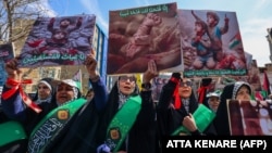 People take part in a funeral procession on April 5 for seven Islamic Revolutionary Guards Corps members killed in a strike in Syria, which Tehran has blamed on Israel. 