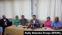 Bosnian Minister for Social Affairs Adnan Delic (center) holds a press conference at the Pazaric Institute for the Care of Mentally Disabled Children and Youth in Sarajevo on August 16. 