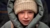 Anna, 10, cries next to the body of her brother Yuriy, 27, during his funeral in Kalynivka, near Kyiv. Kulyk, a civilian who was a volunteer in the armed forces of Ukraine, was killed during a rocket attack on February 15 in Lyman.