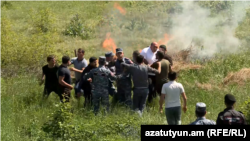 Residents of Kirants attempt to burn a plot of land. One of the local men was heard shouting, “It represents my sweat and the sweat of my mother and father. I won’t let an Azerbaijani enjoy it!”