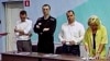 Aleksei Navalny (second from left) listens as the latest verdict against him is read out on August 4. 