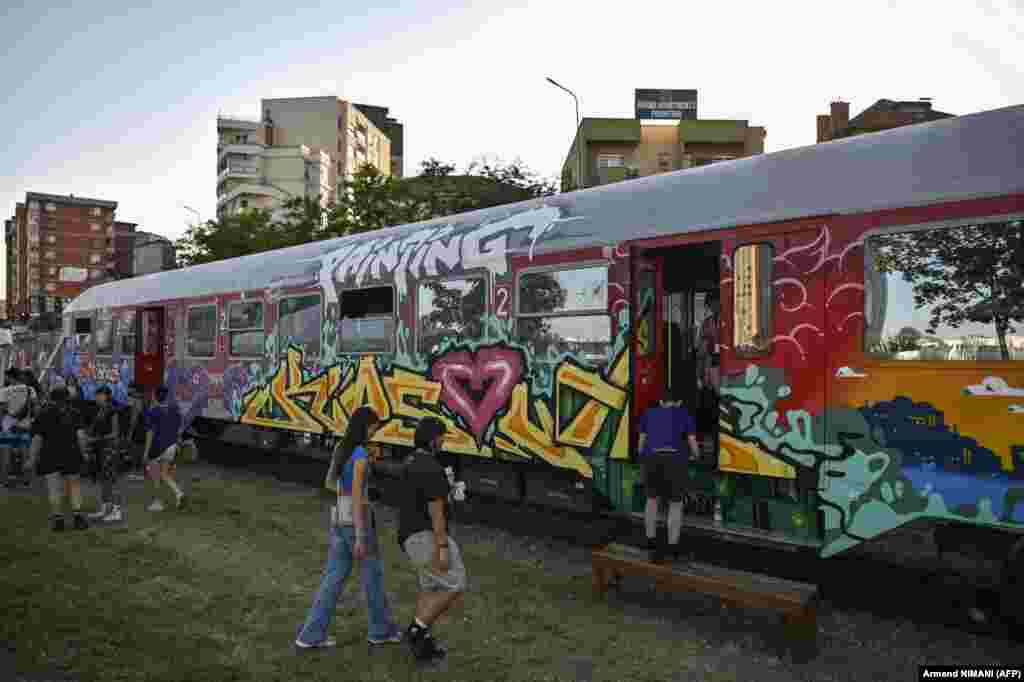 Visitors enter a railway carriage painted by Mexican artist Sprayverse and Polish artist BC ESOBE. &nbsp;