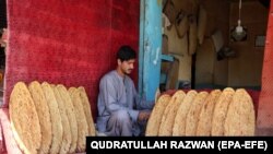 An Afghan man sells bread on a roadside in Kandahar, Afghanistan.