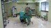 Sarajevo, Bosnia and Herzegovina -- A heart surgeon sitting in the OR scrolling on his phone