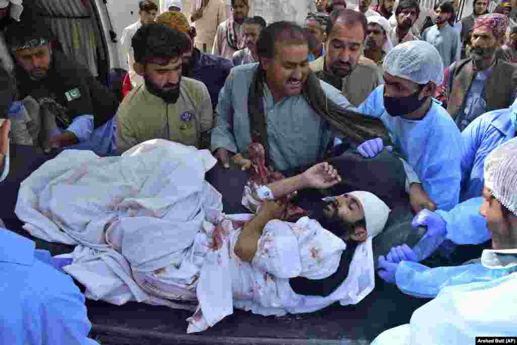 Paramedics and volunteers transport a wounded man to hospital in the city of Quetta after a blast ripped through a religious procession on September 29 in the Mastung district of Pakistan&#39;s southwestern Balochistan Province. The deadly attack, a suspected suicide bombing, is said to have killed dozens during a birthday celebration for Islam&#39;s Prophet Muhammad.