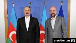 Azerbaijani President Ilham Aliyev poses with European Council President Charles Michel in Brussels on July 14.