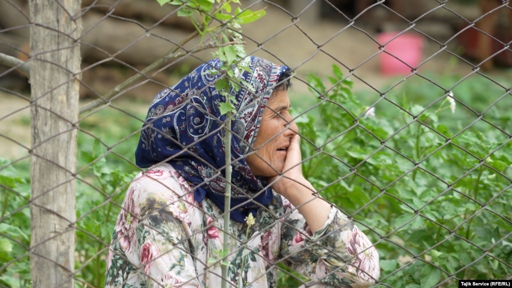 A resident of Khumgaron village near Panjakent sits in her vegetable garden. Her house is not far from the pool where mine runoff and emissions are stored. The villagers are demanding compensation from the Zarafshon mine for polluting the nearby environment.