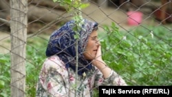 A resident of Khumgaron village near Panjakent sits in her vegetable garden. Her house is not far from the pool where mine runoff and emissions are stored. The villagers are demanding compensation from the Zarafshon mine for polluting the nearby environment.