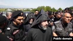 Armenia - Catholicos Garegin II and other clergymen break through a police cordon at the Sardarapat memorial, May 28, 2024.