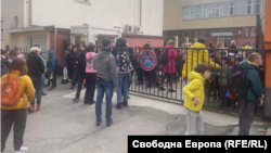 Children and teachers gather outside a Sofia school on March 27 that received an e-mailed bomb threat. 