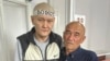 Kazakh journalist Duman Mukhammedkarim (left) and his father, Almaz Tilepov, in a courtroom (file photo)