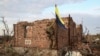 A Ukrainian soldier raises his country's flag over the frontline village of Andriyivka in the Donetsk region on September 16. 