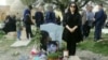 Nika Shakarami's mother, Nasrin, stands beside her daughter's grave. (file photo)