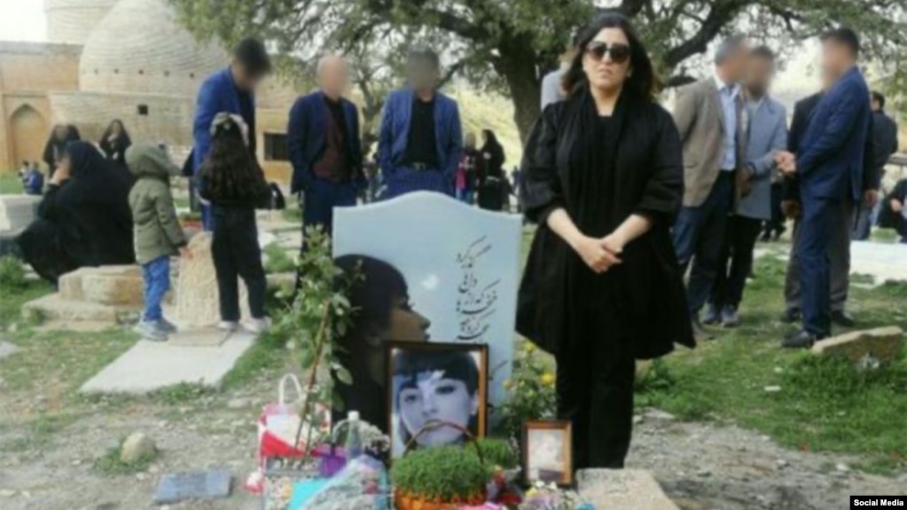 Nika Shakarami's mother, Nasrin, stands beside her daughter's grave. (file photo)