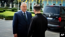 Ukrainian President Volodymyr Zelenskiy (right) welcomes Hungarian Prime Minister Viktor Orban in Kyiv on July 2.