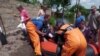 Ukrainian rescuers help pull local residents from a boat during an evacuation from a flooded area