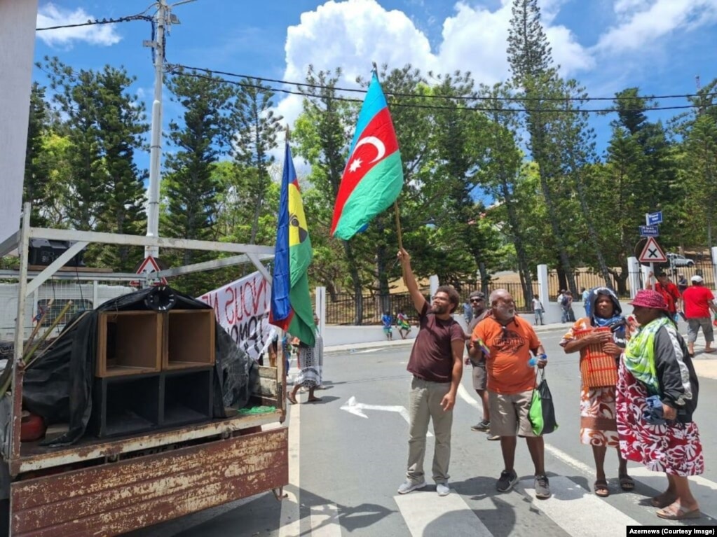 Protesters in Noumea, New Caledonia, wave an Azerbaijani flag. This January 2024 image is one of several showing flags and symbols of the distant Caucasus country being wielded by indigenous Kanak people ahead of the mass unrest that is currently roiling New Caledonia.&nbsp; &nbsp;