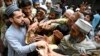 Men collect free bread from a distribution point in Peshawar, Pakistan, on April 3. The latest data forecast 27 percent inflation in the impoverished Islamic nation for 2023 and warned that unemployment will continue to rise.