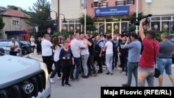 Residents and police scuffle outside a Serbian-run bank in North Mitrovica on May 21, when Kosovar police closed six such institutions.