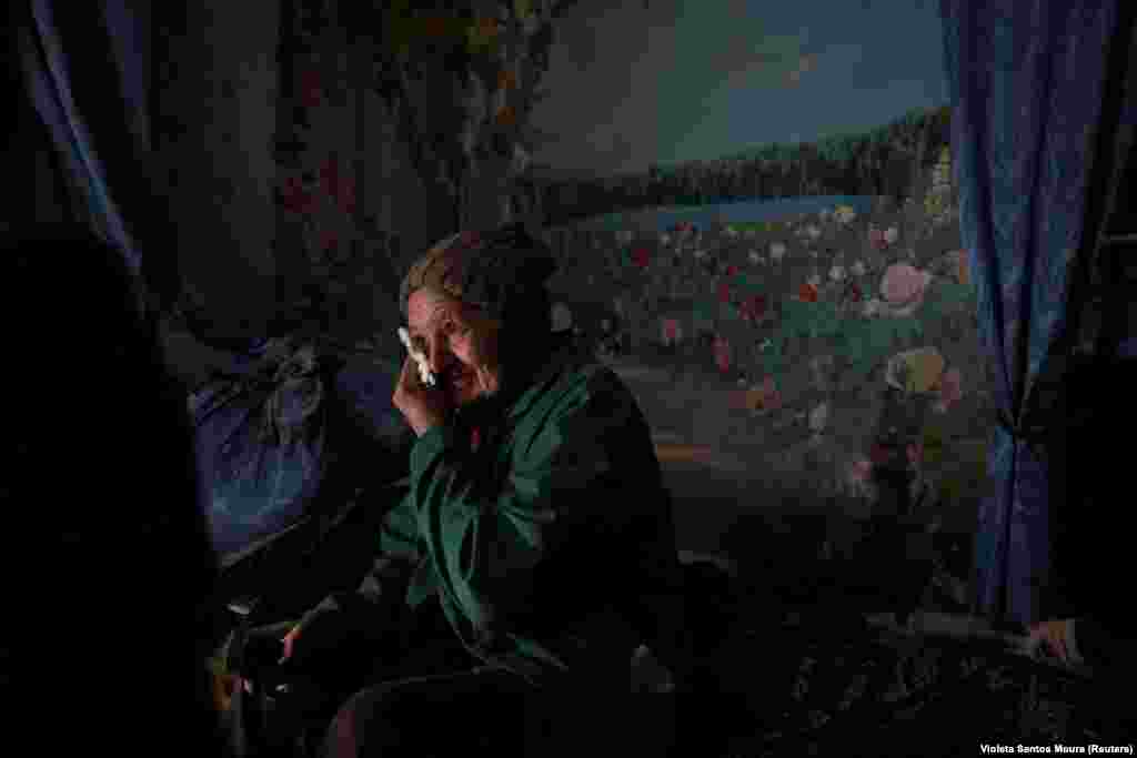 Lyubov Vasilivna, 71, cries as she lists the reasons she cannot evacuate from the house where she was born in the village of Semenivka, near the frontline town of Avdiyivka, in the eastern Donetsk region of Ukraine.