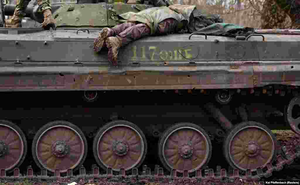 The body of a dead Ukrainian soldier atop a tank near Bakhmut on April 9.