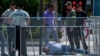 A suspect is detained after a shooting incident involving Slovak Prime Minister Robert Fico at a Slovak government meeting in Handlova, Slovakia, on May 15. Fico, who was injured, was rushed to a local hospital.
