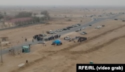 Zhetybai protesters block a road.