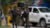 Police officers prepare to take position outside the residence of former Prime Minister Imran Khan,in Lahore, Pakistan, on August 5. 