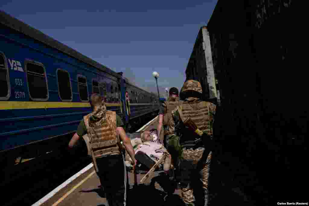 A wounded man is carried away from the train station.&nbsp; Russia did not immediately comment on the incident. Moscow has stepped up air strikes in the past few days as Ukraine prepares for a counteroffensive, which Kyiv hopes will change the dynamic of Russia&#39;s more than 14-month-old war in Ukraine.