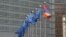 Belgium - EU and Armenian flags fly outside the EU headquarters in Brussels.