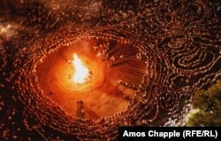 Rings of dancers circle a bonfire on August 19 as traditional music is performed at the Zheravna Festival in Bulgaria. (Amos Chapple, RFE/RL's Central Newsroom)