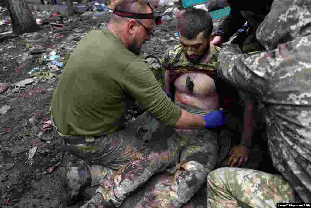 Military paramedics treat a wounded Ukrainian soldier. &quot;Each day we resist here gives more opportunities for other units to prepare for a counterattack,&quot; Philosopher added. &quot;Our vulnerability is that we are starved for shells.&quot;