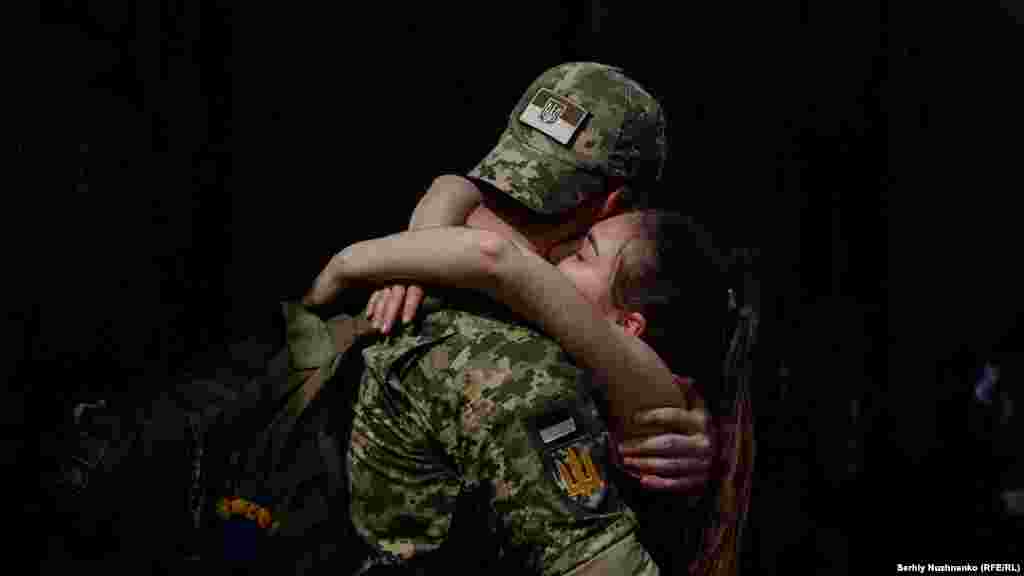 A Ukrainian soldier embraces his partner, who visited him during a short break from his frontline duties at the train station in the eastern Ukrainian city of Kramatorsk. RFE/RL photojournalist Serhiy Nuzhnenko was at the station where he captured these evocative moments as Ukrainian soldiers depart and return from the front line. Nuzhnenko is one of the few reporters granted access to cover combat on the front lines.