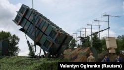 Ukrainian soldiers walk past a launcher of a U.S. Patriot air-defense system at an undisclosed location in Ukraine.